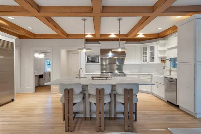 a view of a walk in closet with clothes and shoes