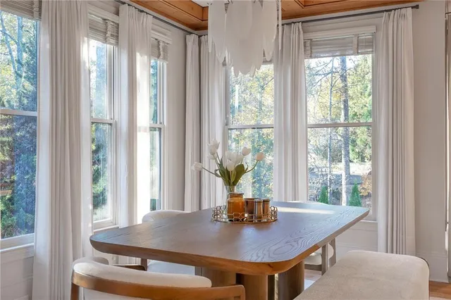 a dining room with a window and chairs