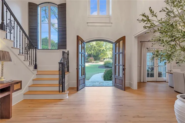 a large white kitchen with a lot of living room and a fireplace