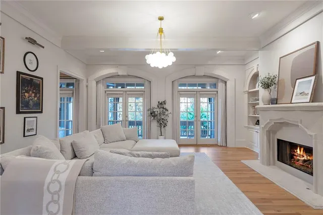a living room with furniture and large windows