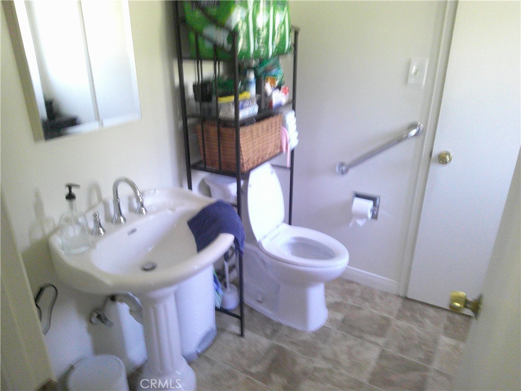 1116 North Old Mill Road Azusa, CA 91702 - Photo 12 of 18 a bathroom with a sink toilet and shower