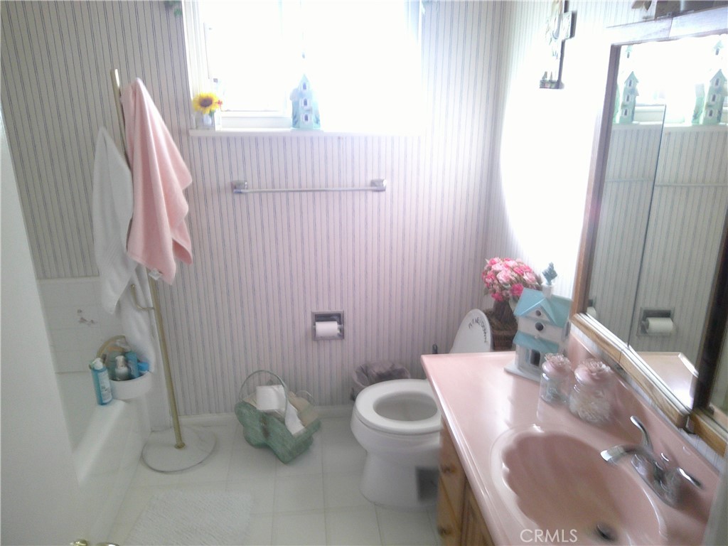 1116 North Old Mill Road Azusa, CA 91702 - Photo 13 of 18 a bathroom with a sink a toilet and a mirror