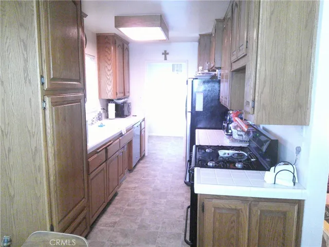 a kitchen with stainless steel appliances a sink stove and refrigerator