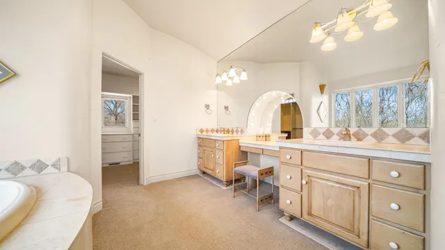 a bedroom with a bed a couch and a window