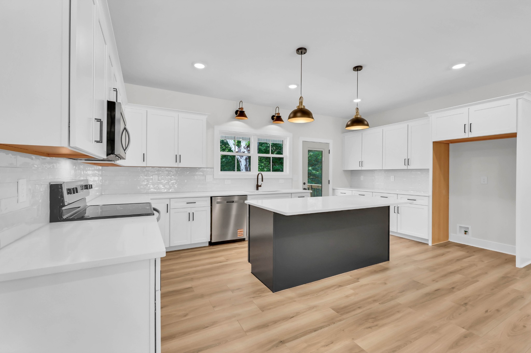 5570 Chambers Road Cumberland Furnace, TN 37051 - Photo 12 of 55 a kitchen with stainless steel appliances kitchen island a sink a stove and a wooden floors