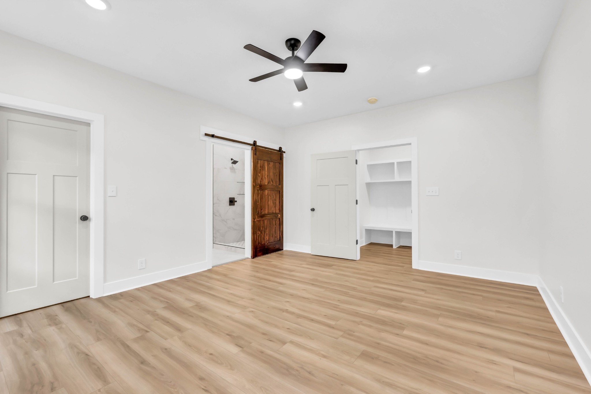 5570 Chambers Road Cumberland Furnace, TN 37051 - Photo 25 of 55 a view of an empty room with wooden floor and a ceiling fan