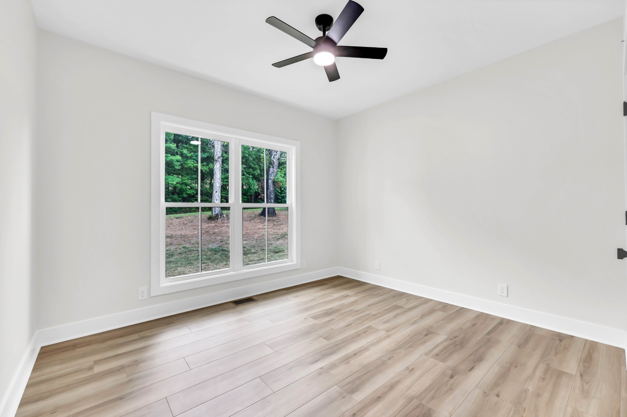 5570 Chambers Road Cumberland Furnace, TN 37051 - Photo 30 of 55 an empty room with wooden floor and windows
