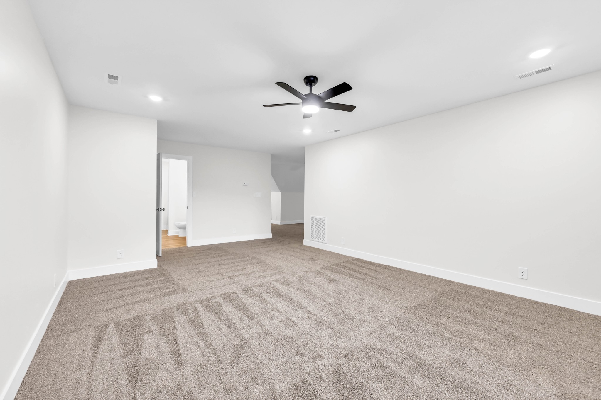 5570 Chambers Road Cumberland Furnace, TN 37051 - Photo 40 of 55 an empty room with a ceiling fan and a rug