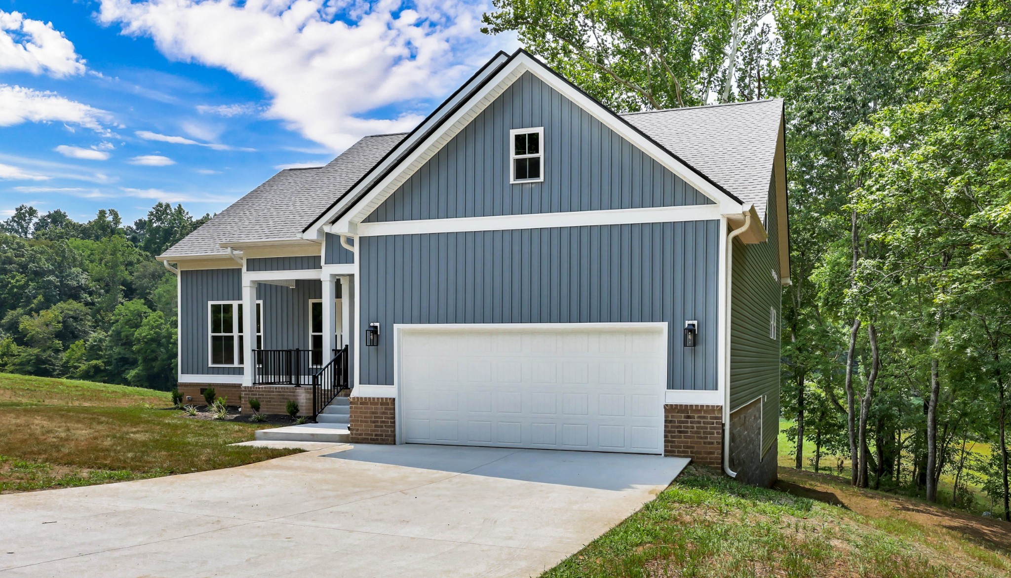 5570 Chambers Road Cumberland Furnace, TN 37051 - Photo 5 of 55 a white house with a small yard plants and trees
