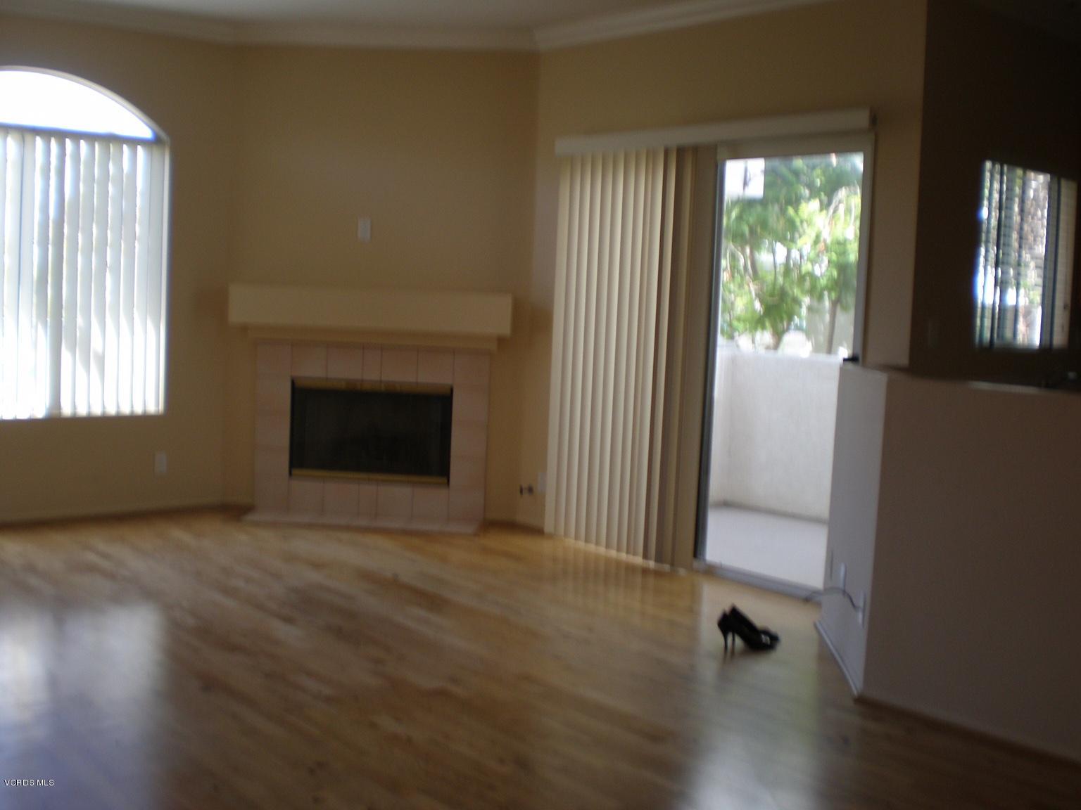11527 Treeview Court Moorpark, CA 93021 - Photo 2 of 3 an empty room with wooden floor and windows