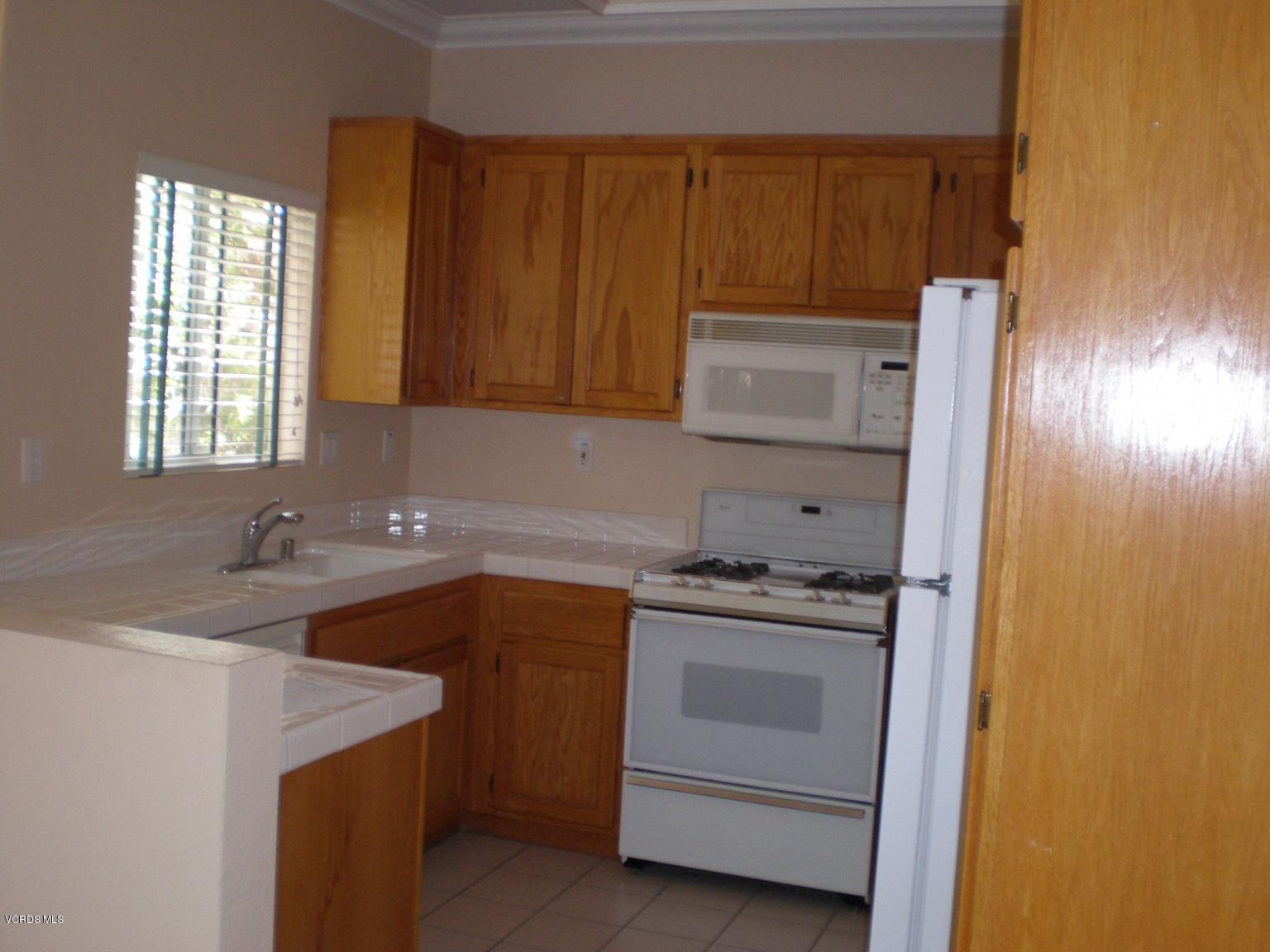 11527 Treeview Court Moorpark, CA 93021 - Photo 3 of 3 a kitchen with a sink stove and cabinets