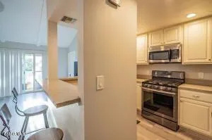 a kitchen with a stove a microwave a sink and cabinets