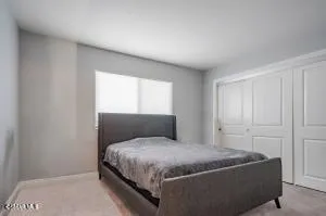 a bedroom with a bed and window