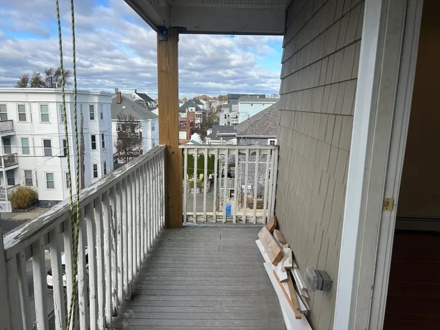 a view of a balcony with wooden floor