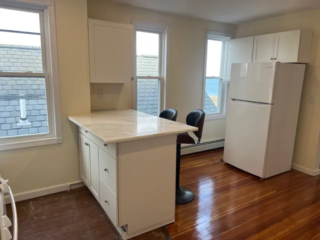 a view of kitchen and wooden floor