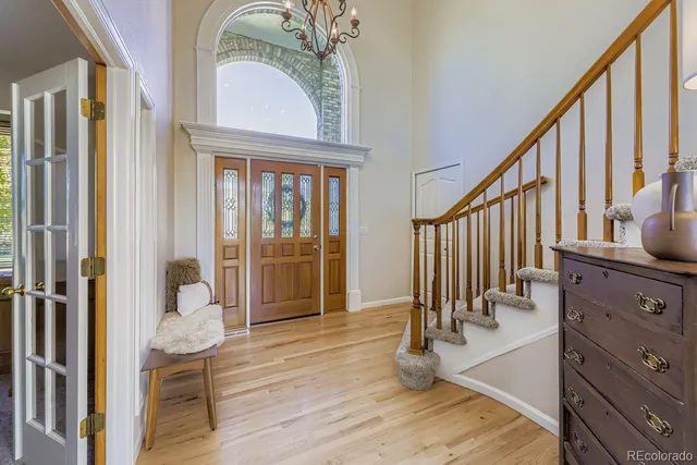 a view of a hallway with wooden floor and staircase