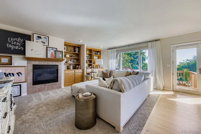 a living room with furniture and a fireplace