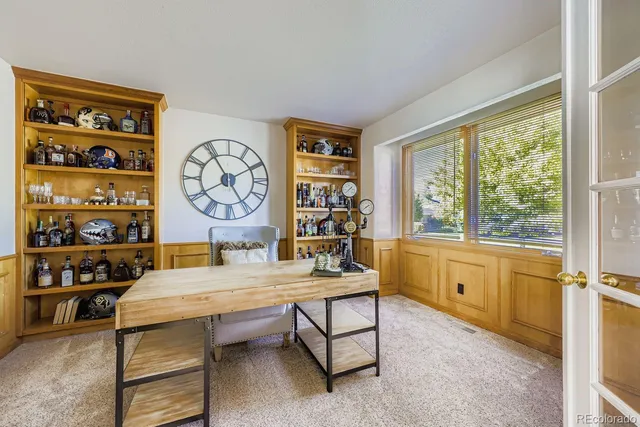 a room with pool table and windows