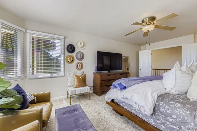 a bedroom with bed and a flat screen tv