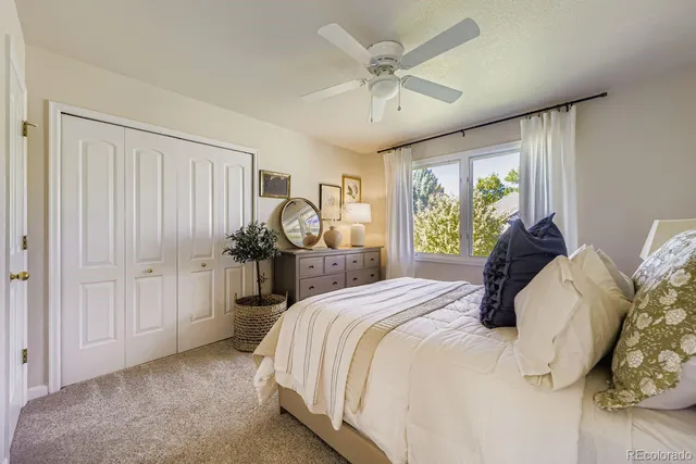 a bedroom with a large bed and a large window