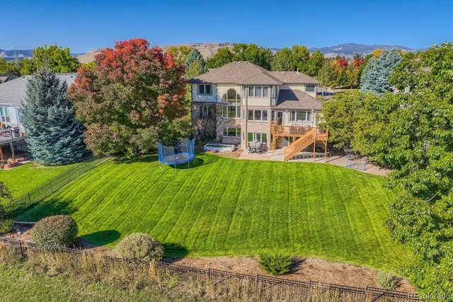a view of a house with a yard and sitting area