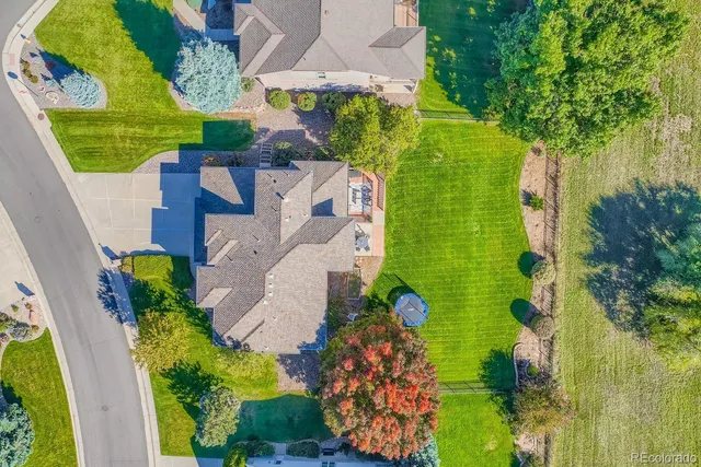an aerial view of a house with a yard