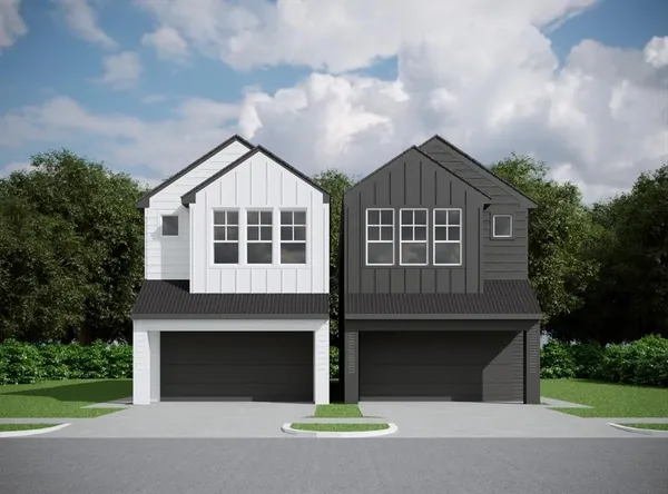 a front view of a house with yard and garage