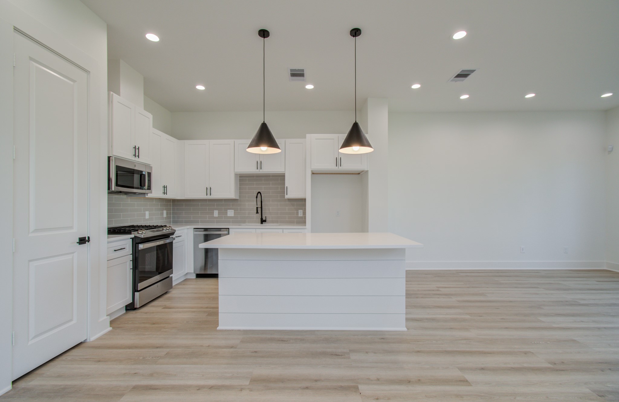 4425 Providence Street Houston, TX 77020 - Photo 12 of 40 a large kitchen with kitchen island a sink stainless steel appliances and cabinets
