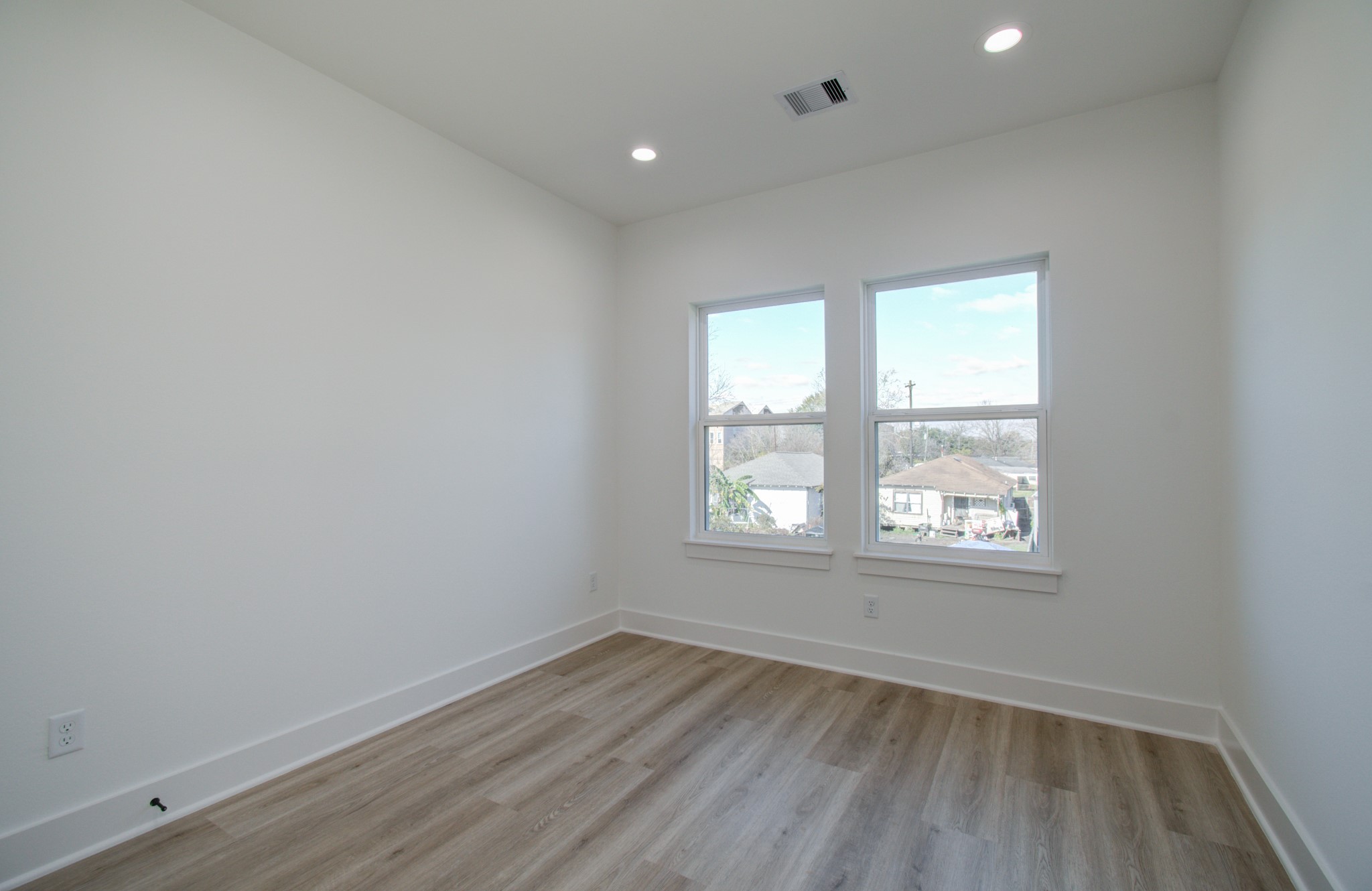 4425 Providence Street Houston, TX 77020 - Photo 22 of 40 an empty room with wooden floor and windows
