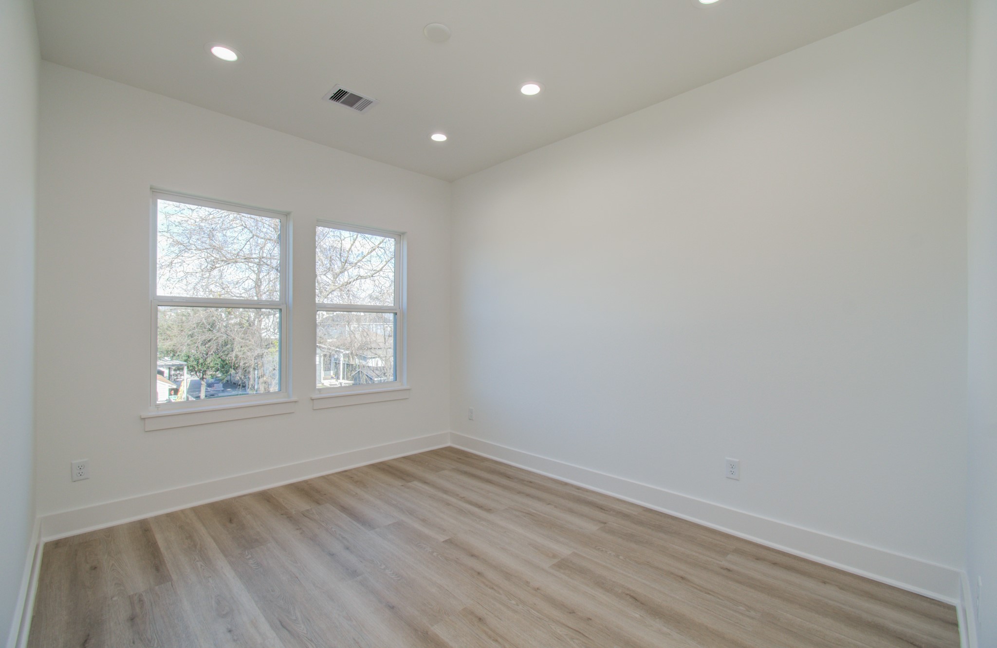 4425 Providence Street Houston, TX 77020 - Photo 24 of 40 an empty room with wooden floor and windows