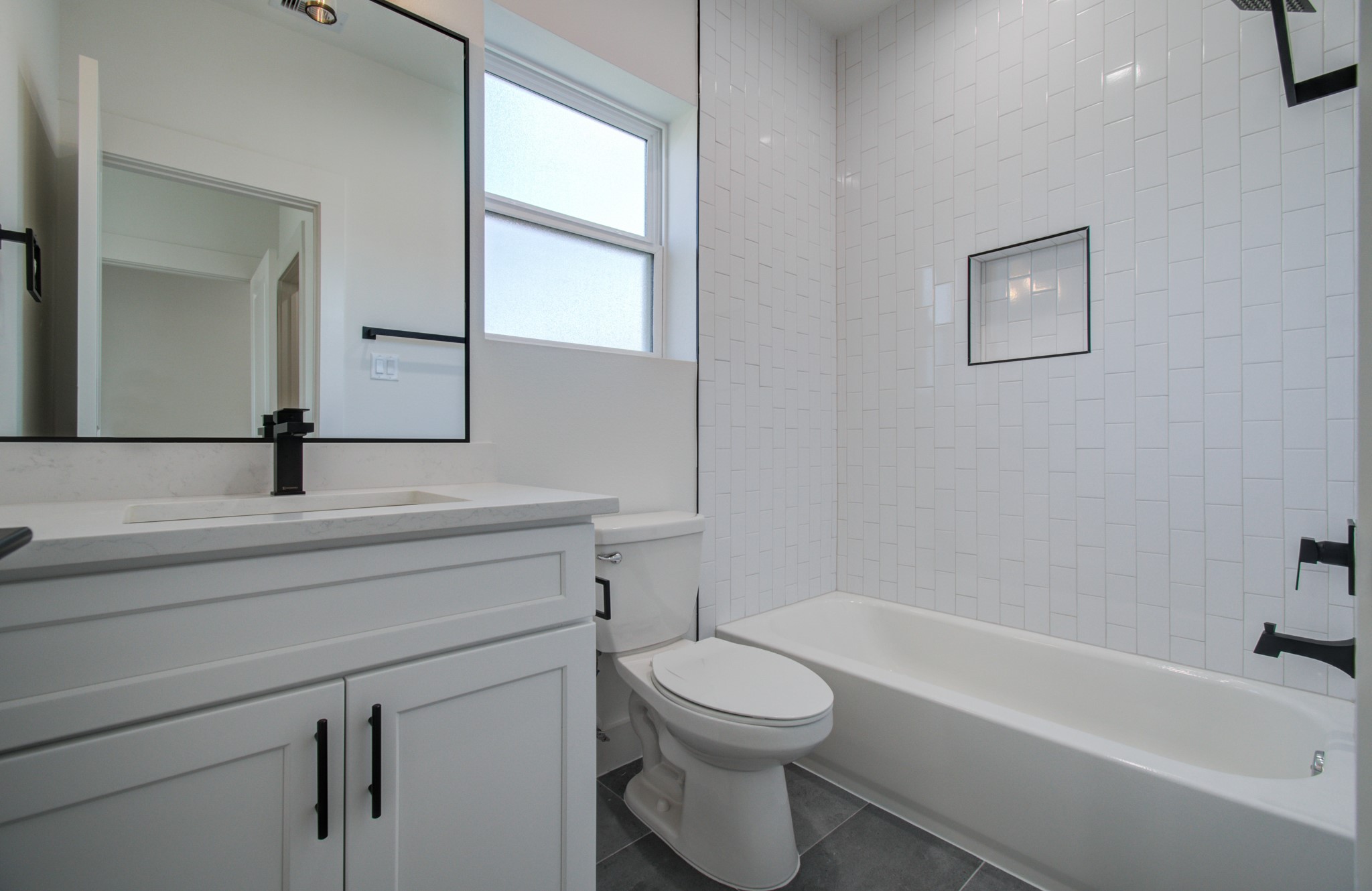 4425 Providence Street Houston, TX 77020 - Photo 26 of 40 a bathroom with a toilet a sink a mirror and bathtub