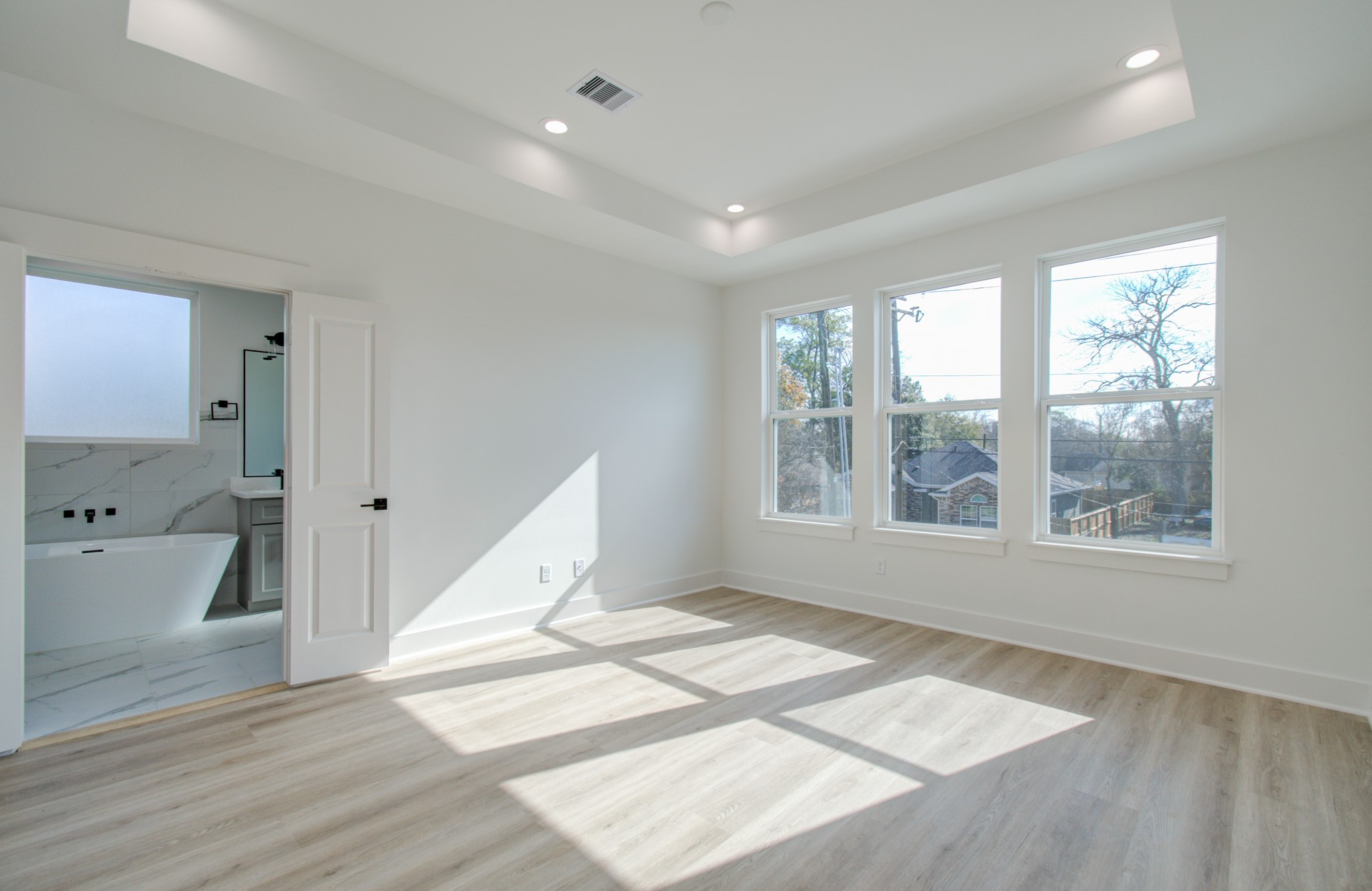 4425 Providence Street Houston, TX 77020 - Photo 27 of 40 a view of an empty room with wooden floor and a window