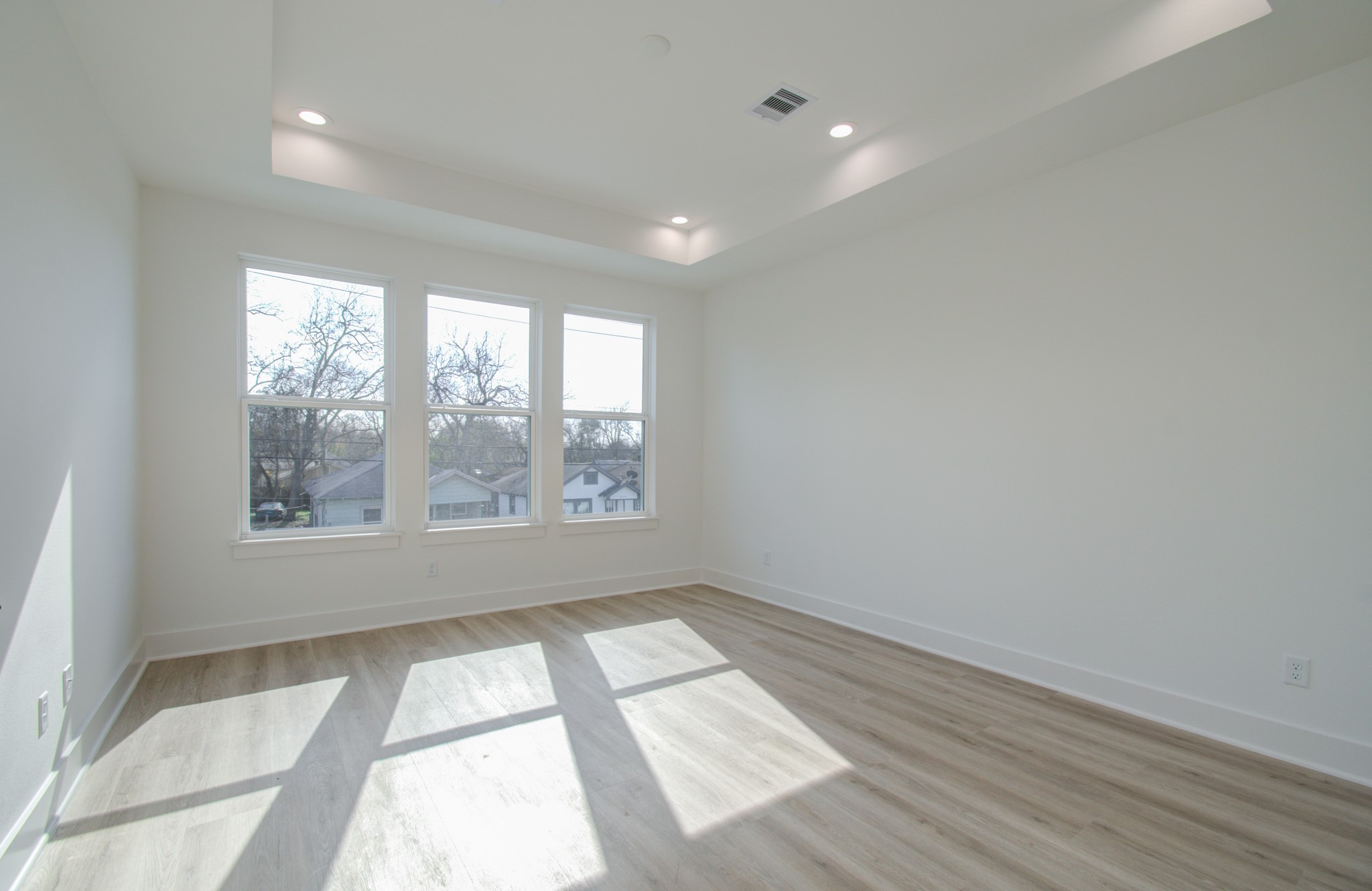 4425 Providence Street Houston, TX 77020 - Photo 28 of 40 an empty room with wooden floor and windows