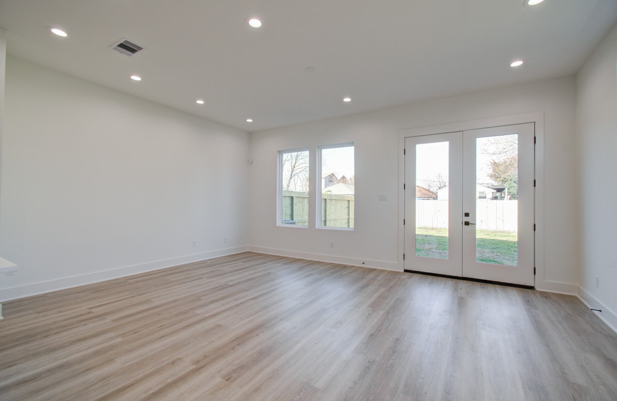 4425 Providence Street Houston, TX 77020 - Photo 9 of 40 an empty room with wooden floor and windows