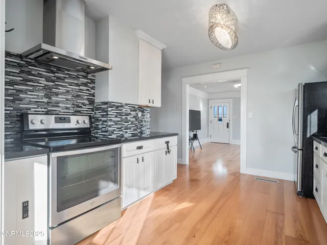 a kitchen with stainless steel appliances granite countertop a stove and cabinets