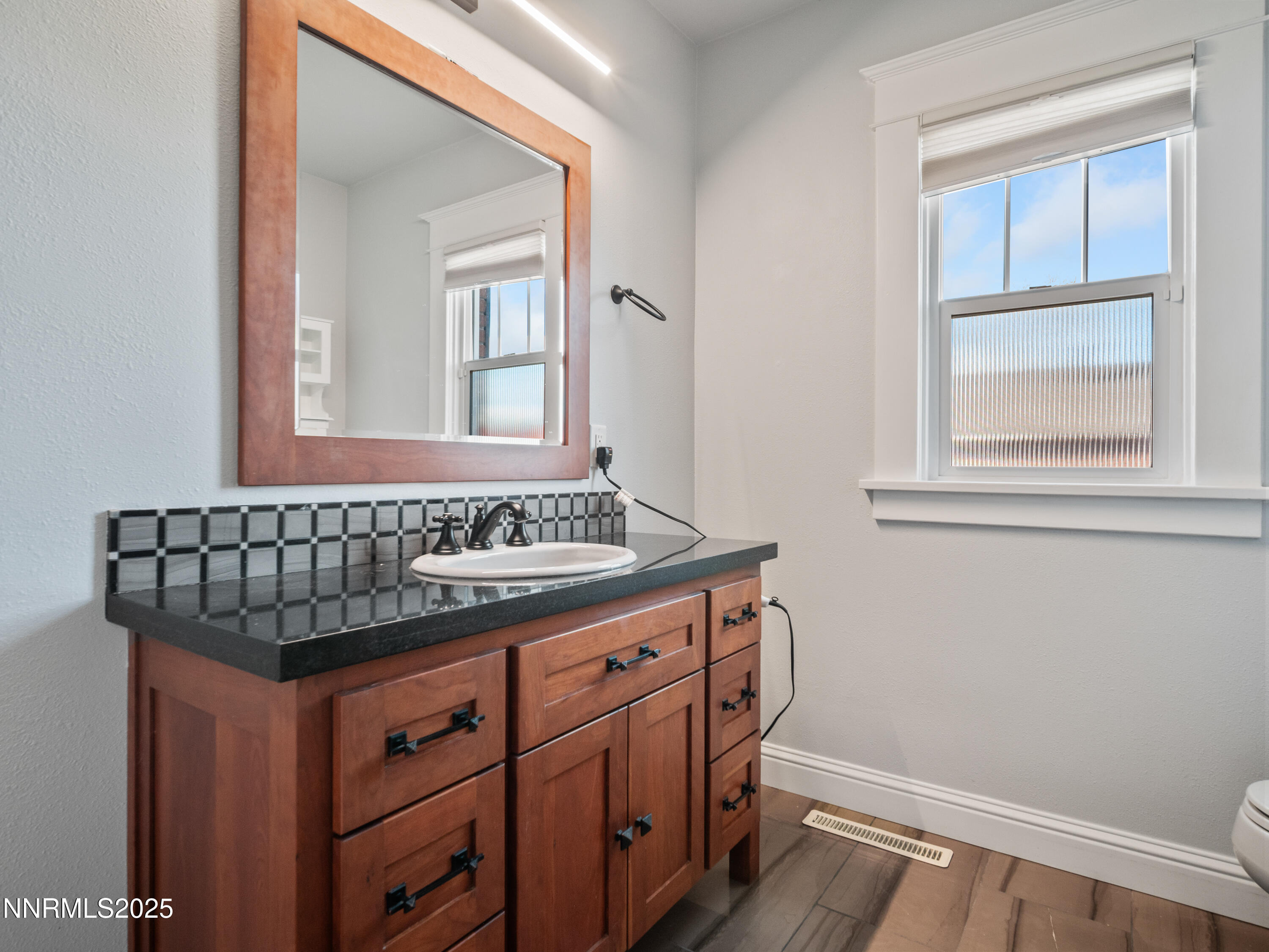 1297 Toler Avenue Gardnerville, NV 89410 - Photo 9 of 31 a bathroom with a sink and a mirror