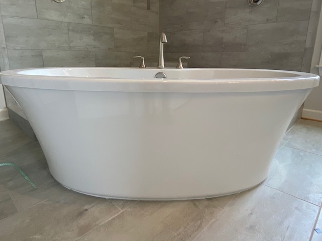 6458 Rutherford Circle Arlington, TN 38002 - Photo 13 of 24 Enjoy soaking in this contemporary freestanding tub or showering in your King Spa Shower, complete with two shower heads, frameless glass, TWO doors, and built in bench!