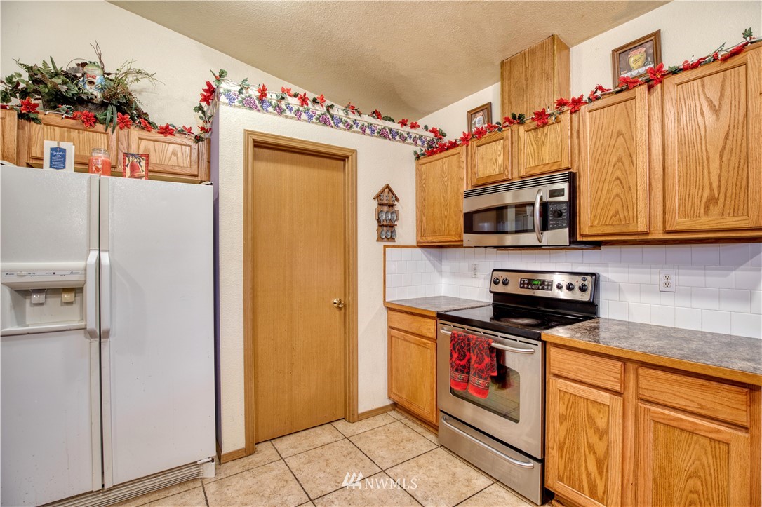 430 Bunker Creek Road Chehalis, WA 98532 - Photo 14 of 30 a kitchen with stainless steel appliances granite countertop a refrigerator and a stove top oven