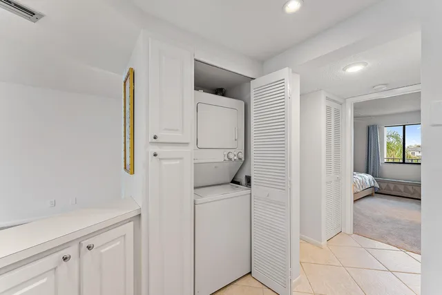 a hallway with white cabinets and wooden floor