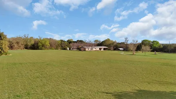 a view of a lake with houses in the background