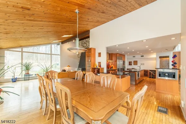 a dining room with furniture and floor to ceiling window