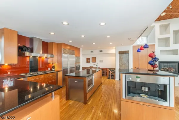 a kitchen with stainless steel appliances granite countertop a stove and a refrigerator