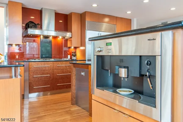 a kitchen view with granite countertop a sink and cabinets