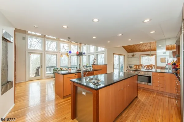a kitchen with stainless steel appliances granite countertop a stove and cabinets