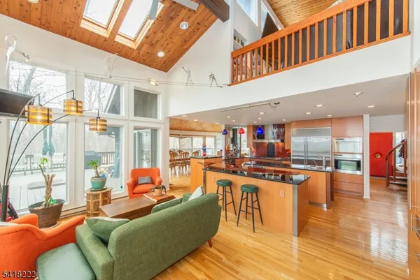 a living room with fireplace furniture and a large window
