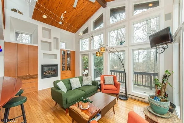 a living room with fireplace furniture and a large window