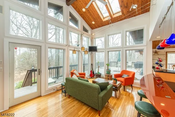 a living room with furniture and floor to ceiling windows