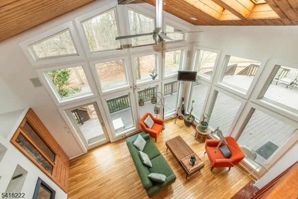 a living room with furniture and floor to ceiling windows