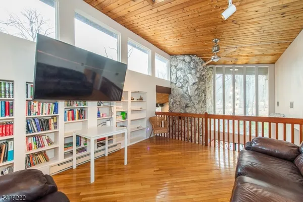 a view of a balcony with furniture and floor to ceiling window