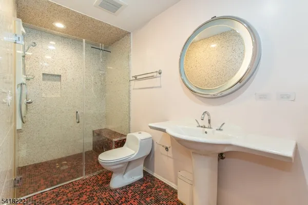 a bathroom with a sink a toilet and a mirror